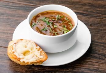 Five Onion Soup in a bowl with bread